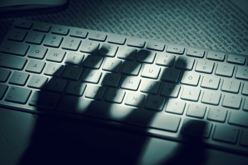 Photo of a hand shadow over a keyboard