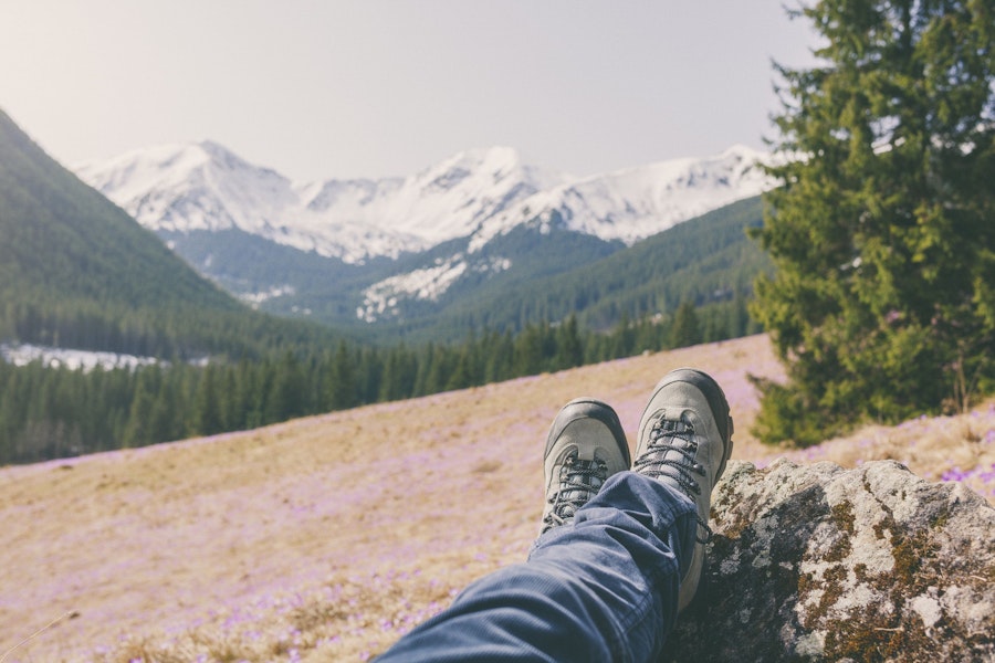 crossed legs in front of mountain