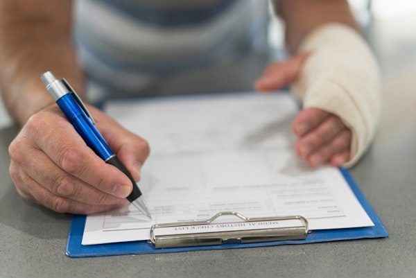 Injured person filling out forms