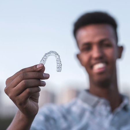 Man holding invisalign