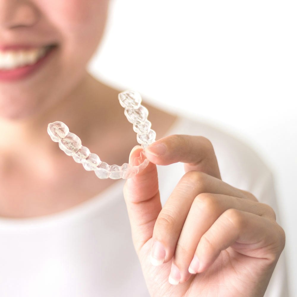 Person holding SureSmile