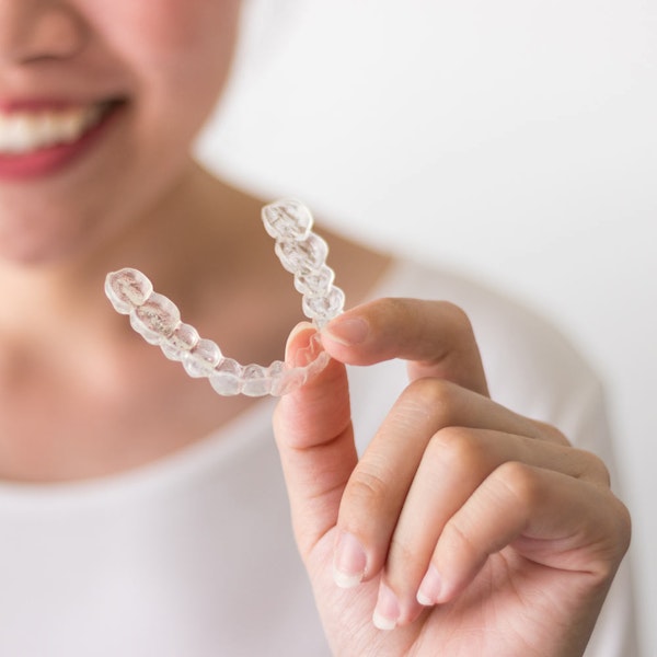 patient holding an Invisalign tray