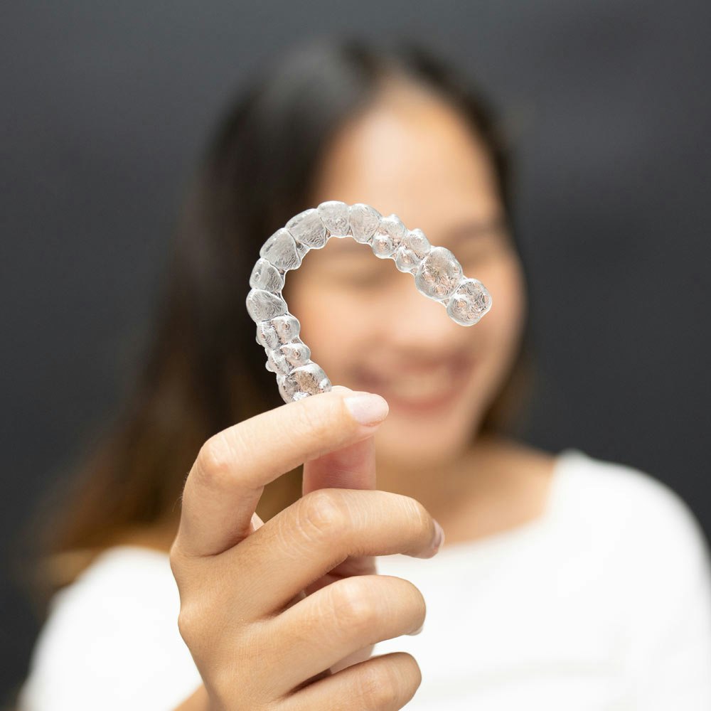 Woman holding Invisalign