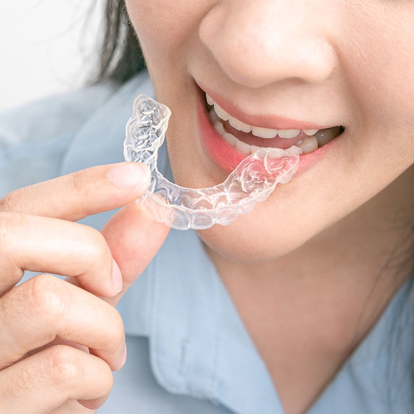 Woman with Invisalign aligner tray