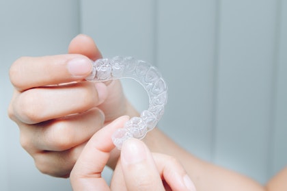 Person holding invisalign