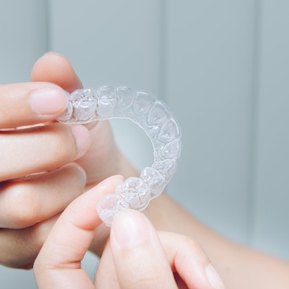 Person holding invisalign