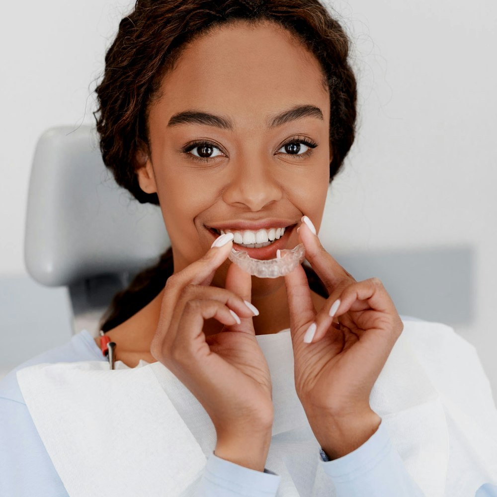 Woman putting on Invisalign