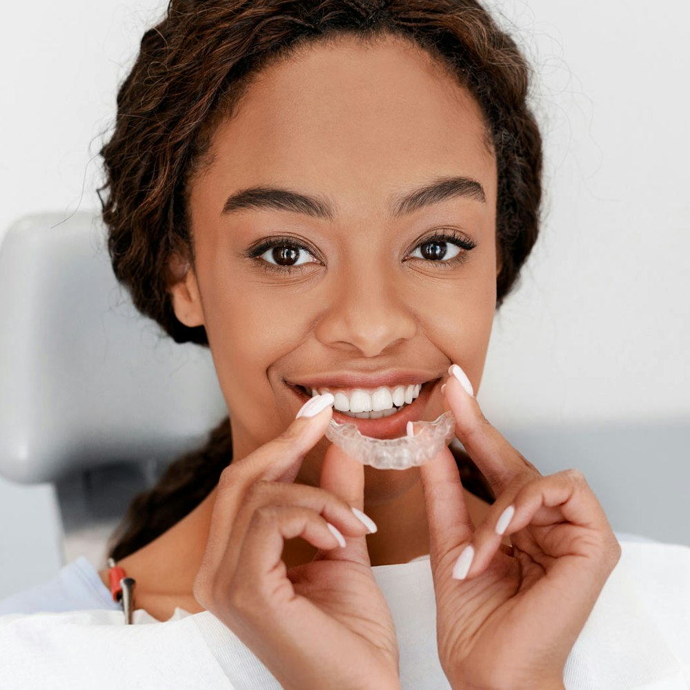 Woman putting on invisalign