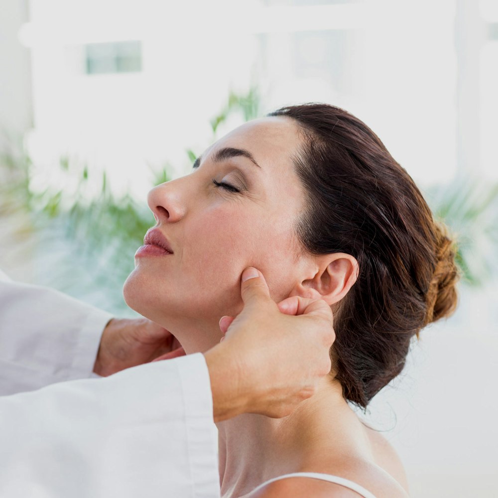 Doctor observing a patient's jaw