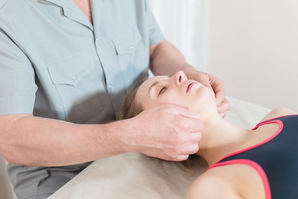 Woman getting jaw massaged