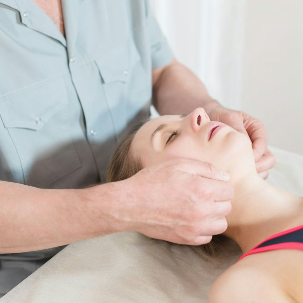 Woman getting jaw massaged