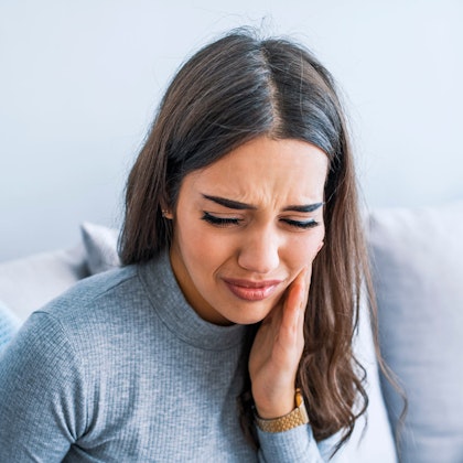 Woman holding jaw