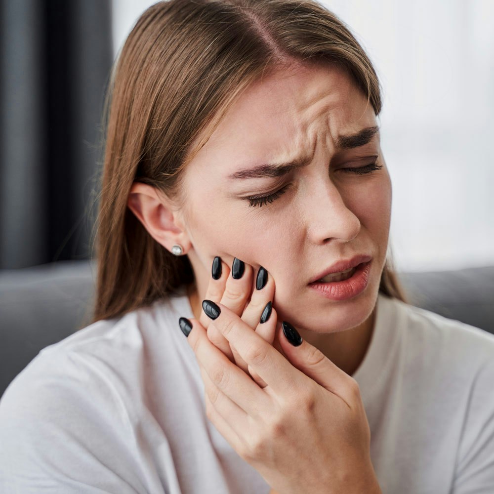 Young woman with TMJ Pain