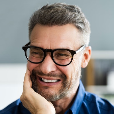 Man holding jaw in pain
