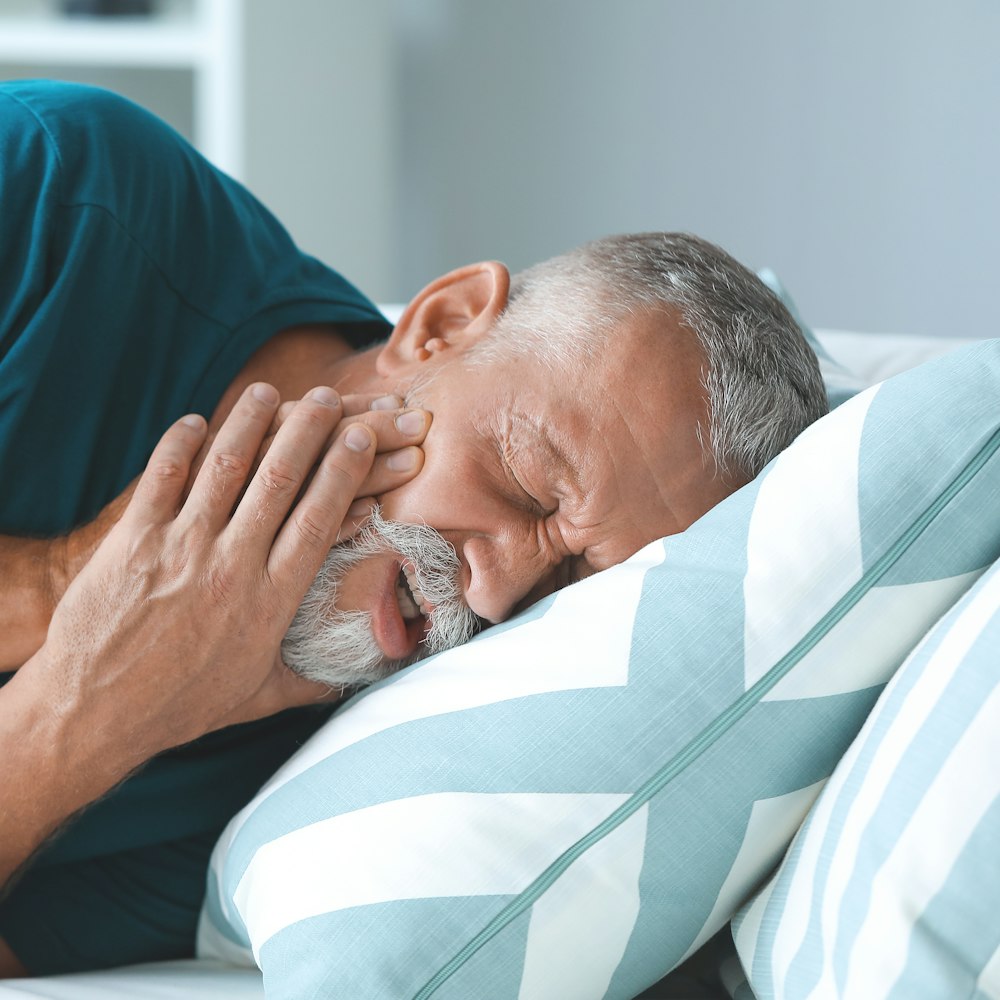 Mature man holding jaw