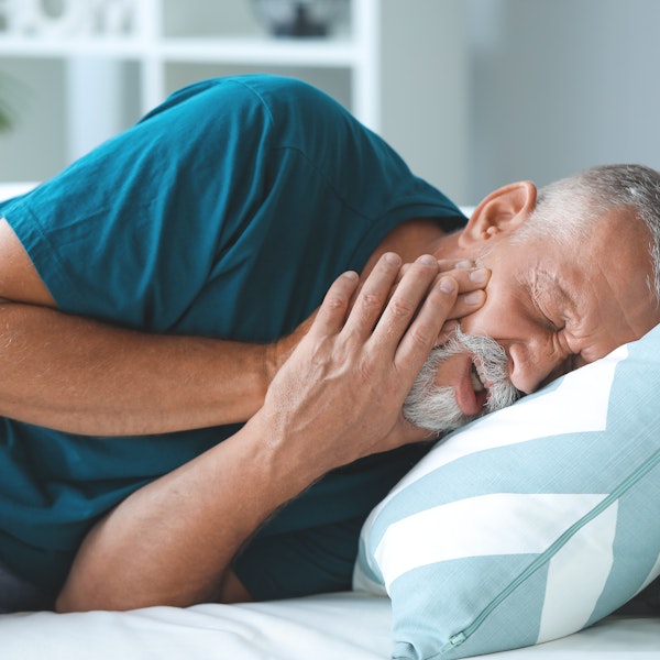 Man holding jaw in pain