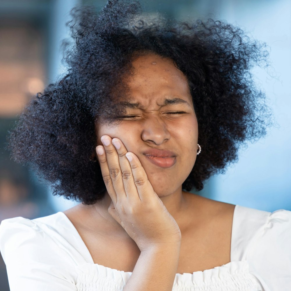 Woman holding jaw in pain
