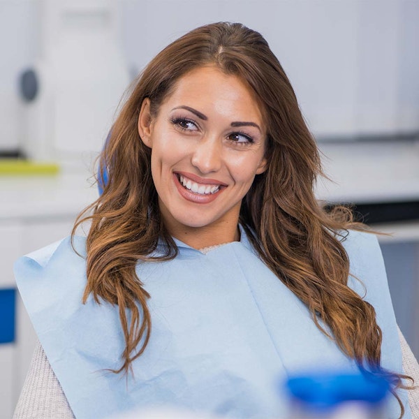Smiling woman wearing dental bib