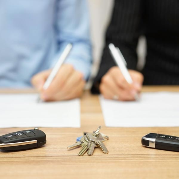 Divorcing couple signing paperwork