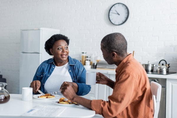 Mature woman talking to son over a meal