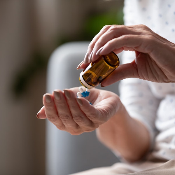 Woman using over-the-counter pain relievers