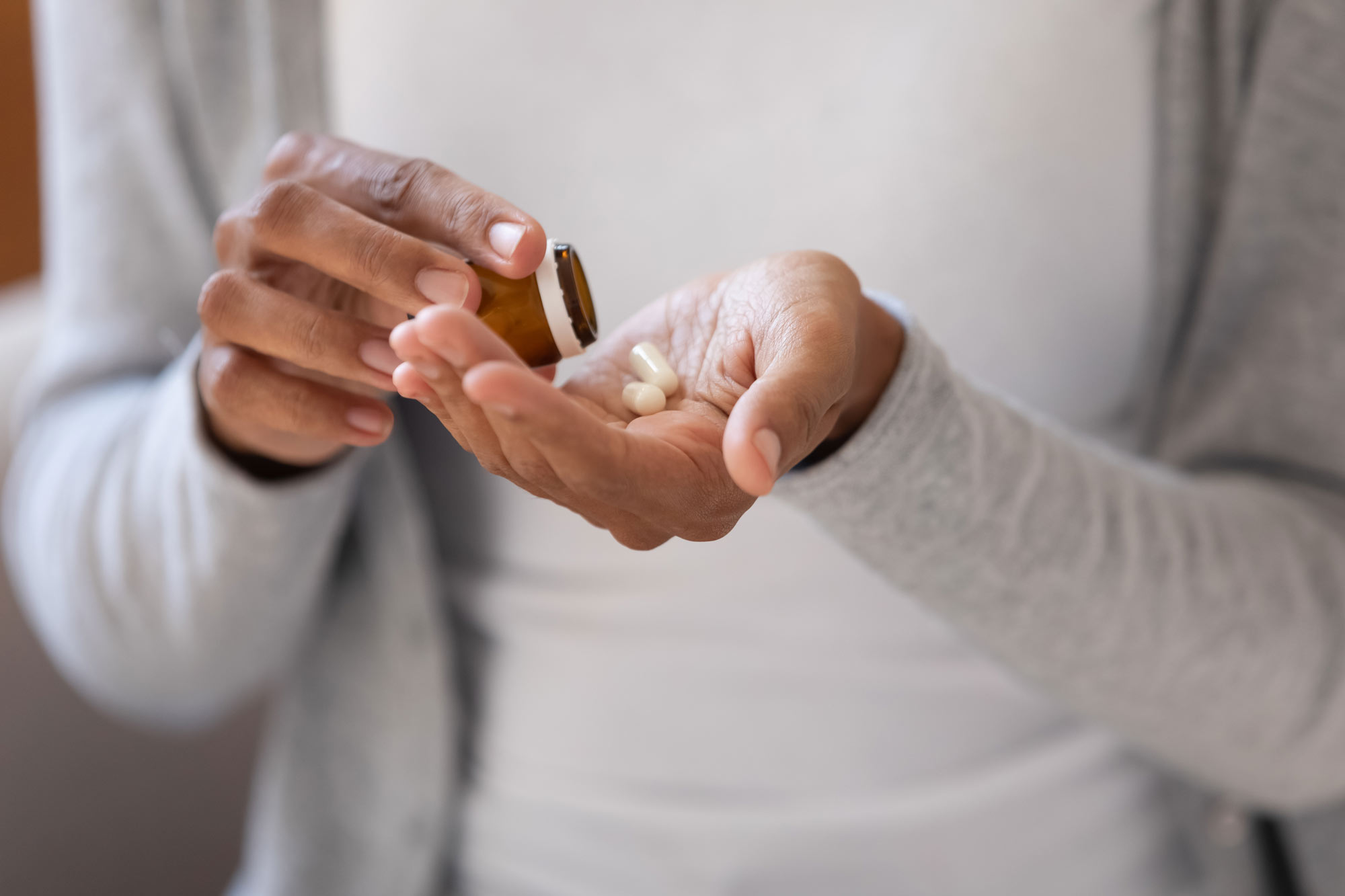 Woman putting pills into hand
