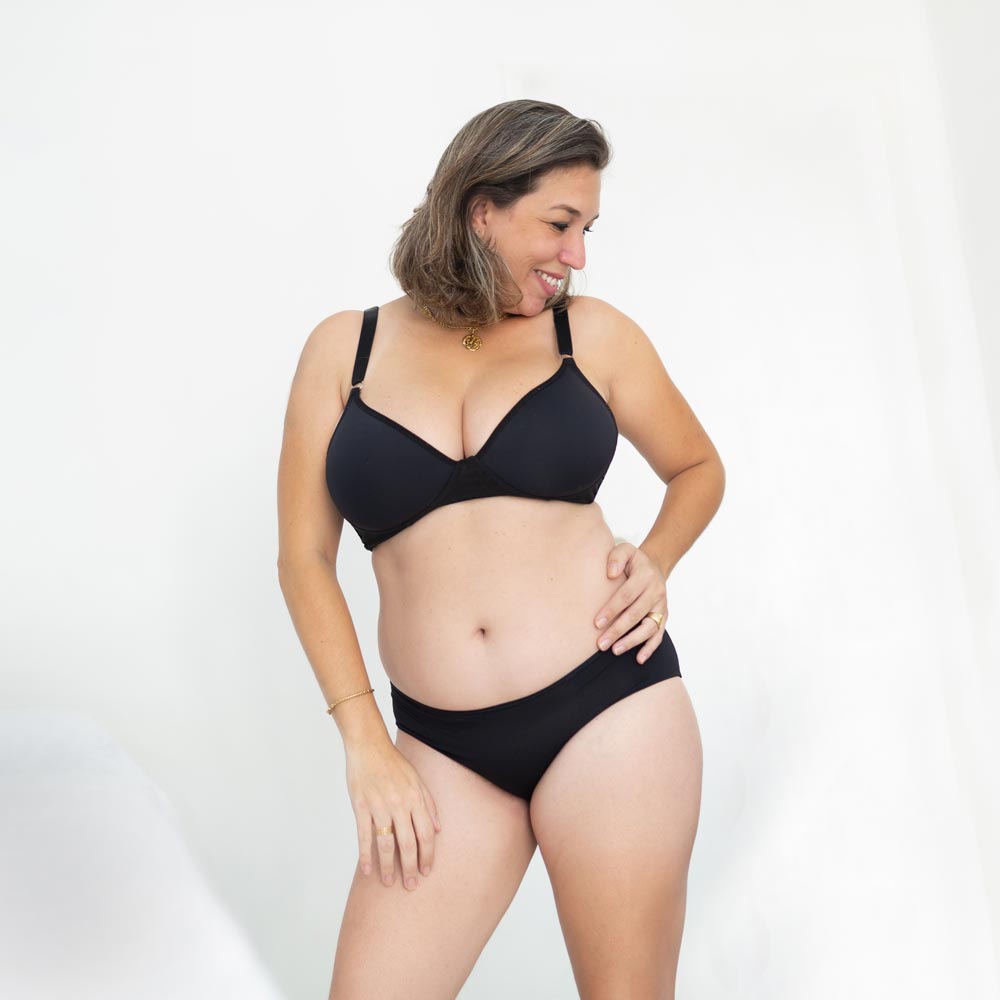 Middle aged woman posing in black underwear