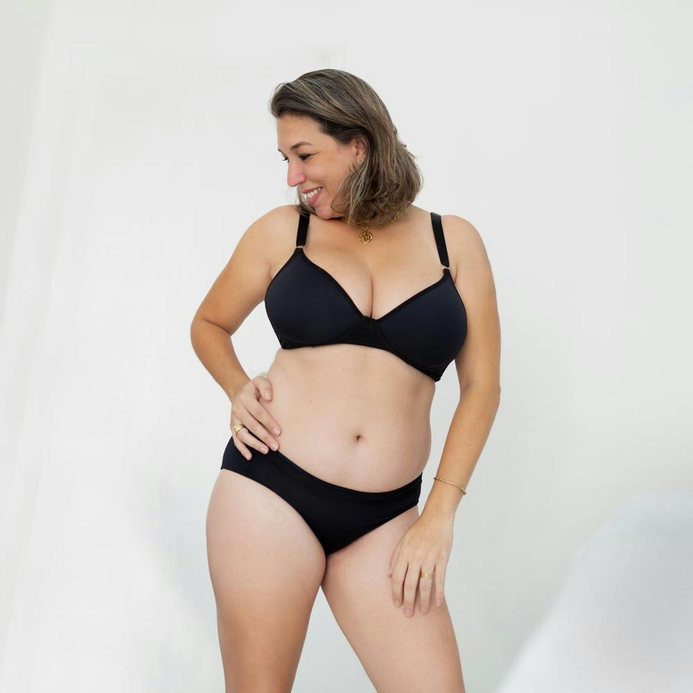 Middle aged woman posing in black underwear