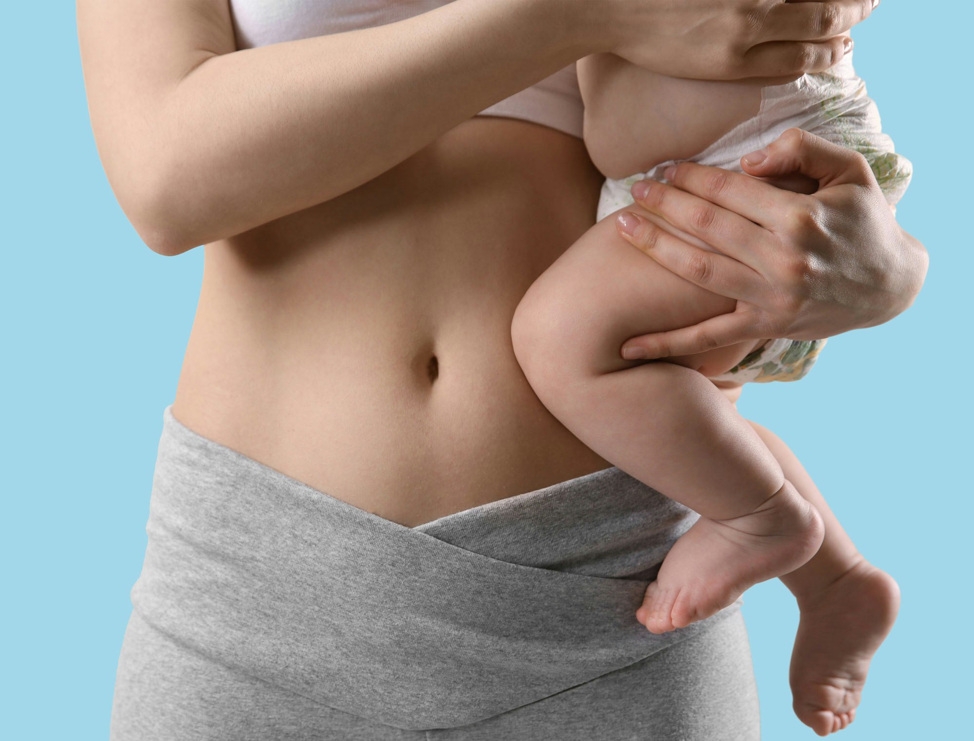 Mom holding baby against blue background