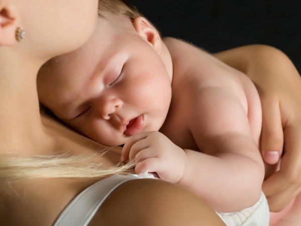 Baby sleeping on mother's shoulder
