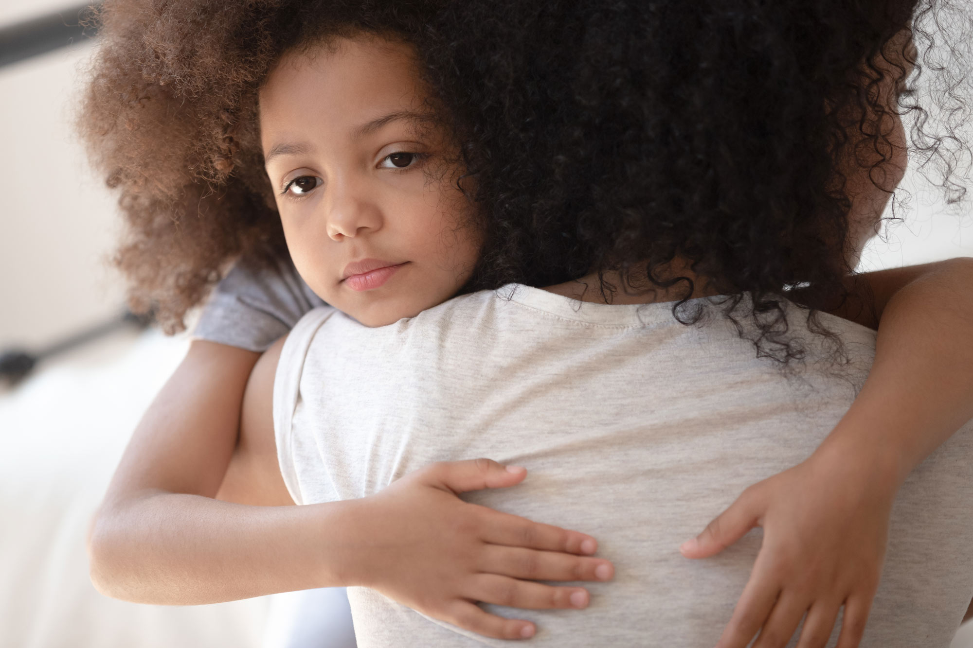 Mother hugging worried daughter