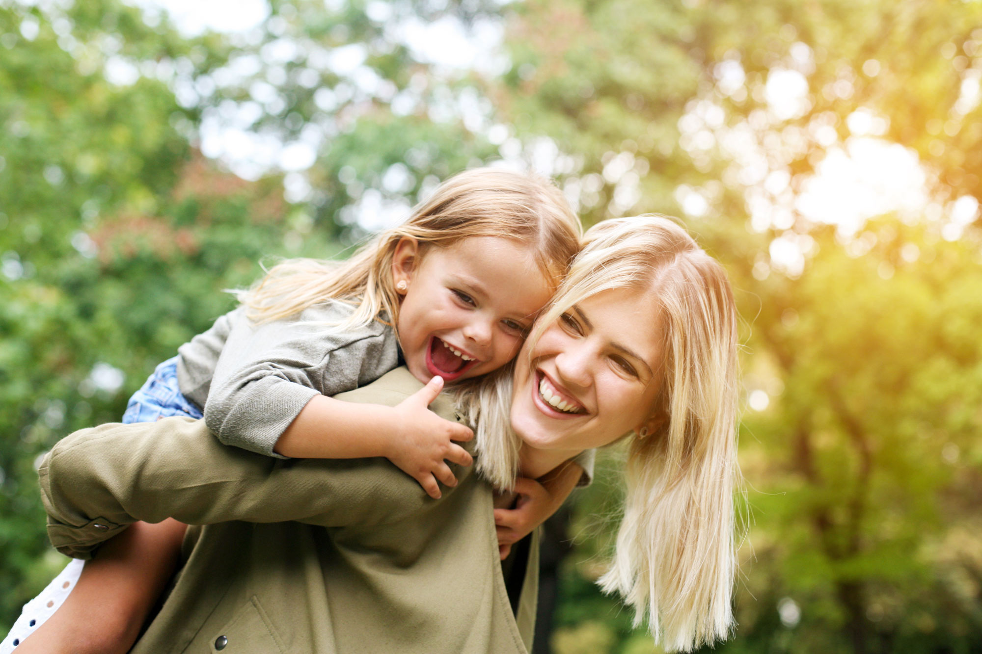 mother and daughter hugging and smiling
