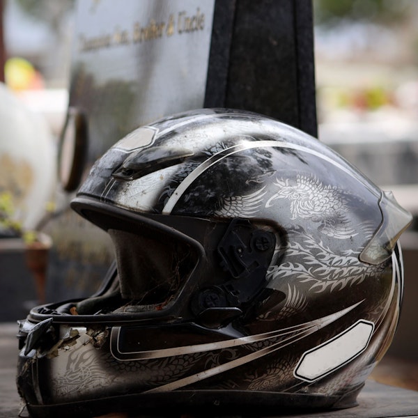 Motorcycle helmet on tombstone