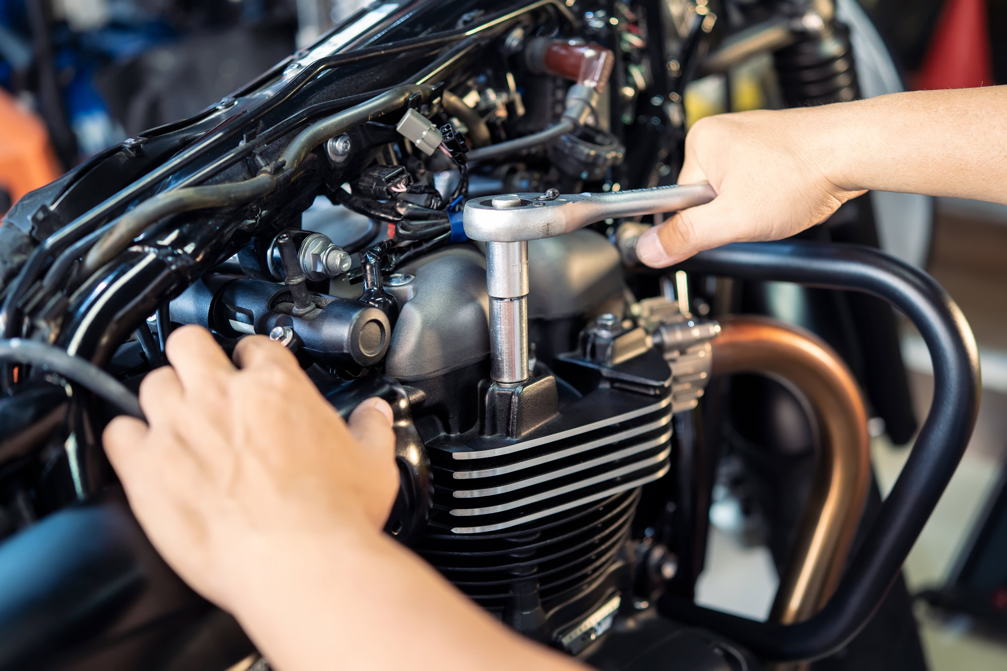 person working on a motorcycle engine