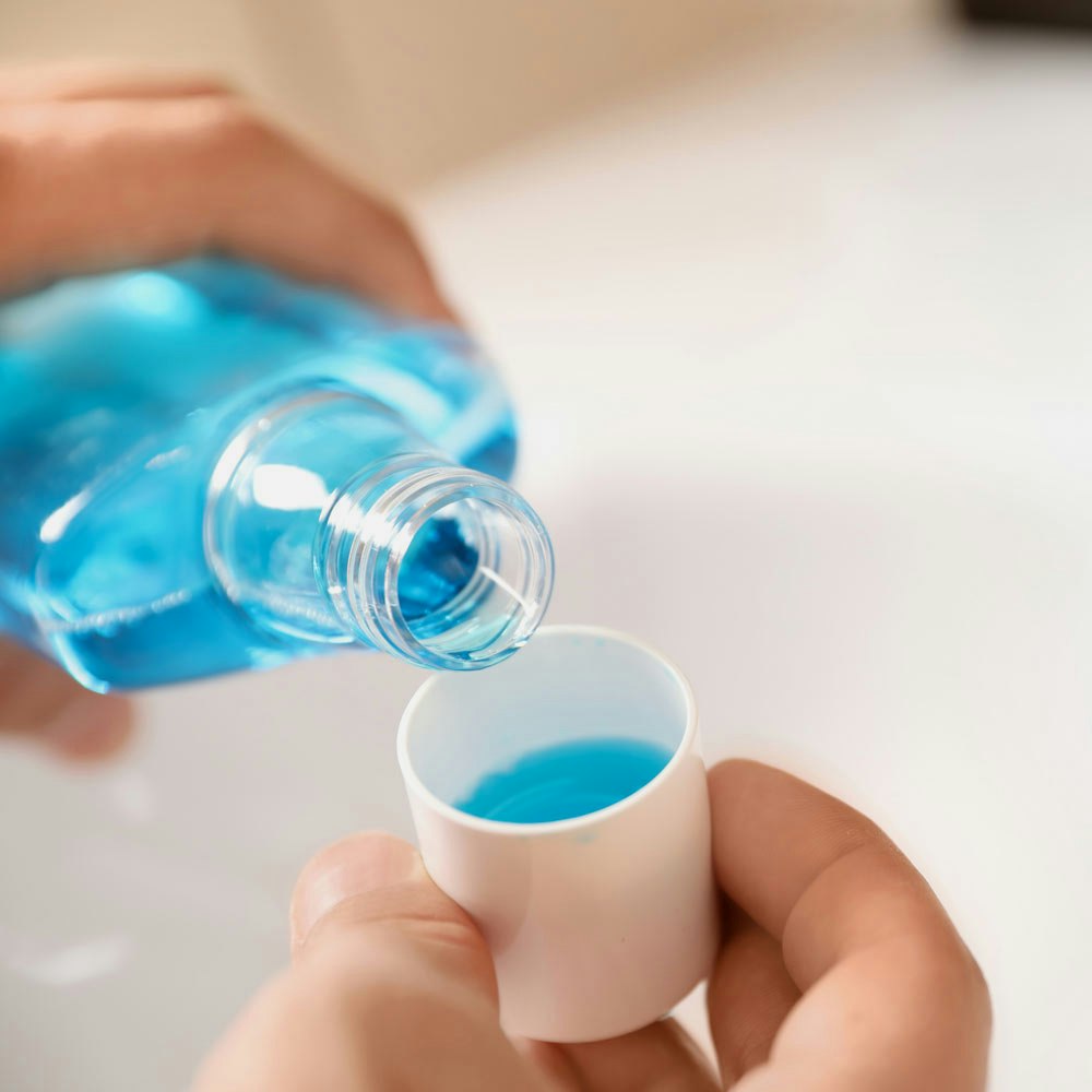 Mouthwash being poured into cup