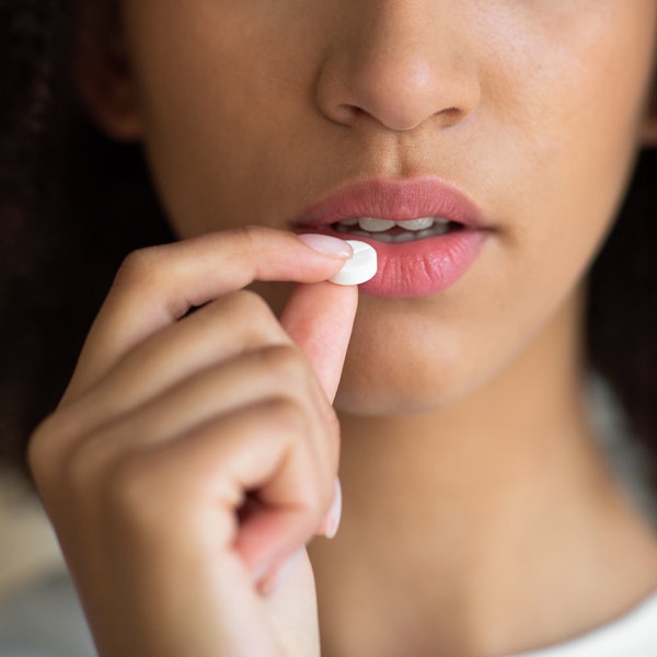 Woman taking an oral sedation pill