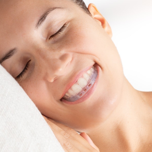 Woman using oral appliance
