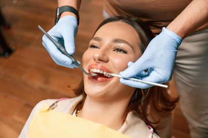 Woman wearing invisalign at the dentist office