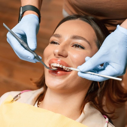 Woman wearing invisalign at the dentist office