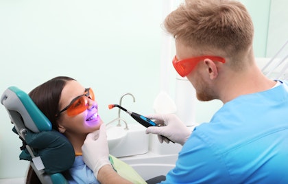Dentist using a tool for whitening