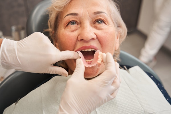 Woman receiving denture