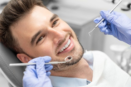 Dentist working on man