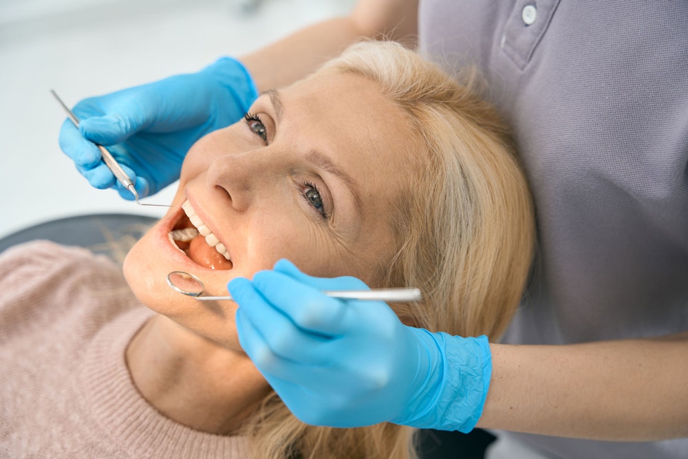Dentist examining patient's teeth