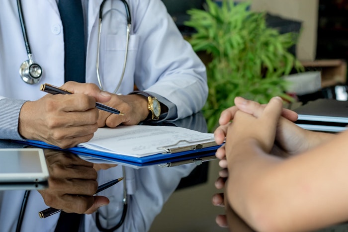 Doctor filling out medical certificate