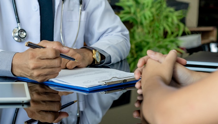 Doctor filling out medical certificate