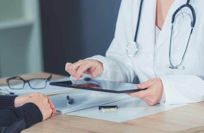 Doctor reviewing report