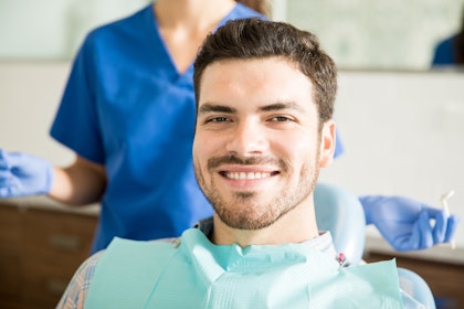 Smiling bearded man in dental chair