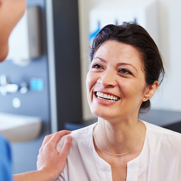 Smiling woman speaking with someone