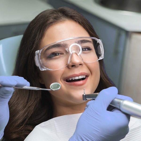 Young dental patient with safety glasses on