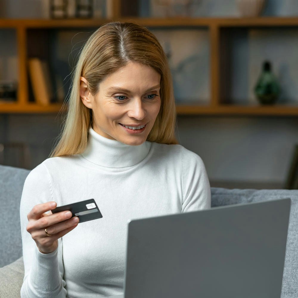 Woman paying on laptop